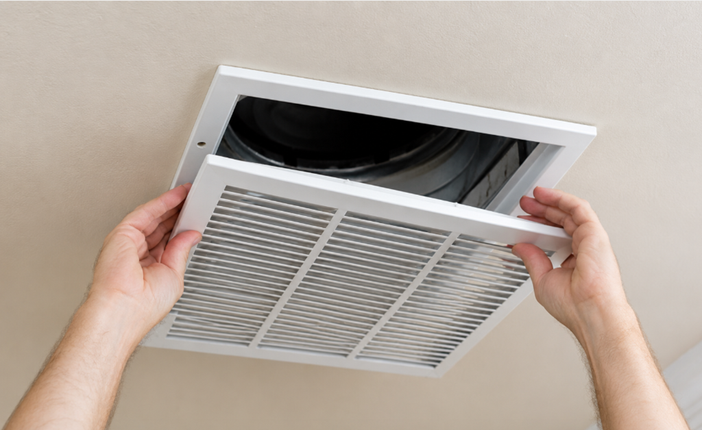 echnician replacing old home air vents with new ventilation covers