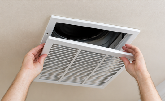 echnician replacing old home air vents with new ventilation covers